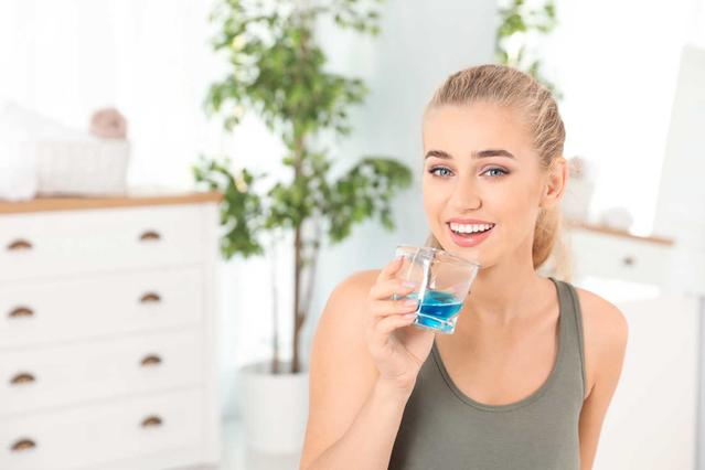 Woman with mouthwash